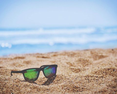 okulary przeciwsłoneczne leżące na plaży