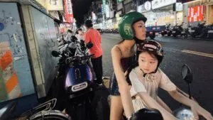 Left Handed Girl 2025 Woman And Child On Moped In Taiwan